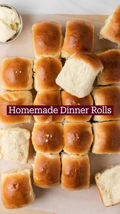 homemade dinner rolls on a cutting board with butter