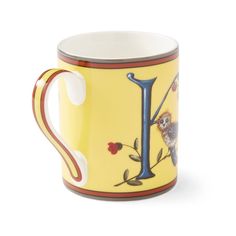 a yellow coffee mug with an i on it