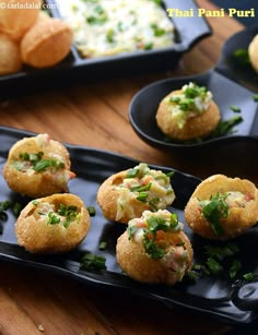 small appetizers on black plates with garnishes