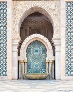 an intricately designed entrance to a building with blue and white tiles on the walls