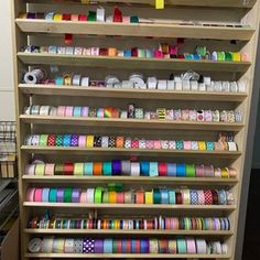 a large shelf filled with lots of different colored tapes