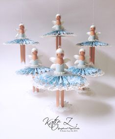 an ornament made to look like some kind of ballerinas with umbrellas hanging from them