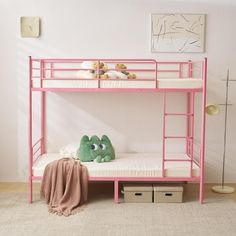 a pink bunk bed with a green stuffed animal sitting on it's bottom shelf