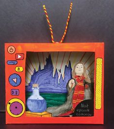 an ornament made to look like a tv screen with a woman holding a vase