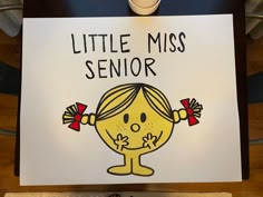 a sign that says little miss senior with a cartoon girl holding her hands up in front of her face