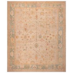 an antique rug with various colors and designs on the border, in neutrals and browns