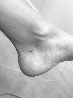 a black and white photo of a person's foot