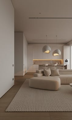 a modern living room with white couches and beige rugs on the wooden floor