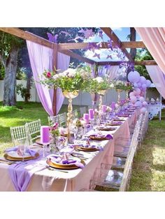 a long table with purple and white decorations