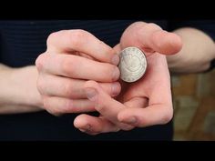 a person holding a coin in their hands