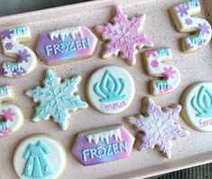 decorated cookies on a pink tray with frosting