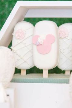 three marshmallows in a white box with pink decorations