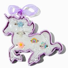 two plastic unicorns with bows on their heads and one has a purple ribbon around its neck