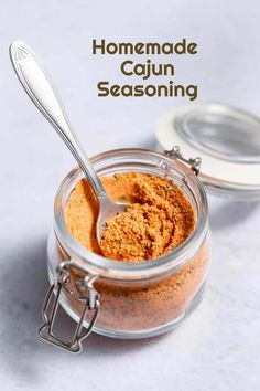 homemade cajun seasoning in a glass jar with a spoon