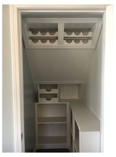 an empty closet with shelves and drawers