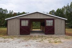 an open garage with two doors and windows