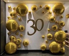 balloons are on display in front of a wall with the number 30 written on it