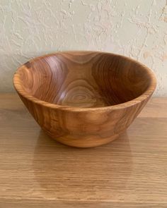 a wooden bowl sitting on top of a table