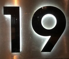 a metal sign with the number nine on it