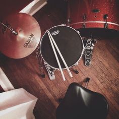 an overhead view of a drum set with sticks and drumsticks on the floor