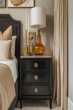 Sophisticated bedroom showing a black nightstand with golden lamp and decor, complementing the neutral-toned bedding. Nightstands With Black Iron Bed, Traditional Bedroom Inspirations, Bedroom With Different Nightstands, Black Bed Nightstand Ideas, Black Nightstand Styling, Black Lacquer Furniture, Vintage Black Furniture, How To Style Black Bedroom Furniture, Bedroom Black Furniture Decor