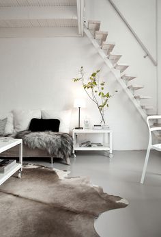 a living room with white walls and furniture