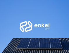 the logo for enkel solar is shown on top of a building with a blue sky in the background