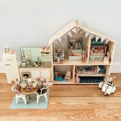 a doll house with furniture and accessories on the floor