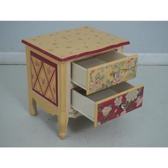 three drawers with flowers painted on them and one drawer opened to show the bottom section