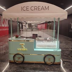 an ice cream cart sitting on top of a marble floor next to a sign that says saber