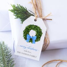 a christmas ornament with a blue bow is tied to a white present box