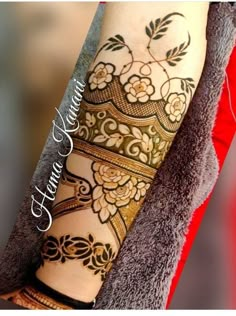 a woman's arm with henna tattoos on it