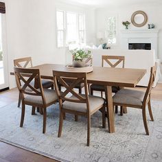 a dining room table with six chairs around it