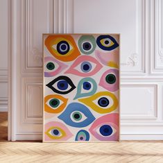 an abstract painting on a white wall next to a wooden floor in front of a door