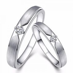 two white gold wedding rings with diamonds on each one and the other in between them