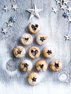 several pastries are arranged in the shape of a christmas tree on a wooden table