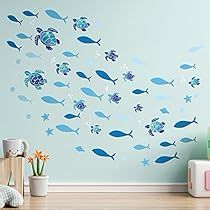 a blue wall with fish and seaweed on it in a child's room