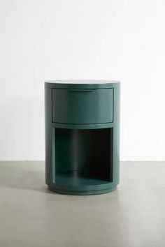 a green round table with a shelf on the bottom and one drawer at the top