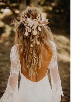 the back of a woman's head with flowers in her hair and an instagram