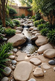 a garden with rocks and water running through it