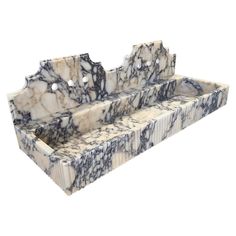 a white and black marble sink sitting on top of a counter