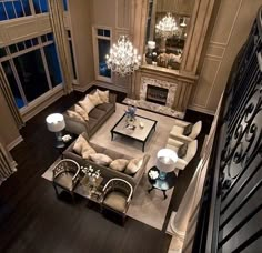 an aerial view of a living room with furniture and chandelier in the center