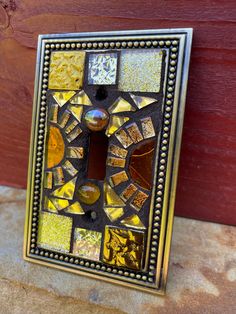 Gold Mosaic single light Switch plate SINGLE TOGGLE stained glass decor.  Add a touch of elegance to your home with our handmade Mosaic light switch cover. Each cover is meticulously crafted, making it a unique and beautiful addition to any room. Not only does it enhance the aesthetic appeal of your space, but it also adds a personal touch that sets it apart from standard switch covers. Upgrade your home decor with our Mosaic light switch cover and enjoy the beauty of handmade craftsmanship. Fabulous wall plate art work for your home!  I have created a beautiful piece of art for your wall plates!   Due to the custom nature, sorry no returns/no exchanges. Please reach out to me before ordering if you are unsure what you want to order and we will work to see that you get the custom plates yo Decorative Light Switch Covers, Gold Mosaic, Custom Plates, Handmade Mosaic, Stained Glass Decor, Plate Art, Switch Plate Covers, Light Switch Plates, Switch Covers