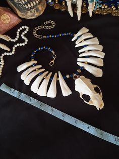 "Have a Look at This Beautiful Mink Skull Necklace! There are 14 Real Buffalo Teeth Beaded on this Necklace, With Blue Beads and Gold Beads. The Mink Skull is in Good Shape, Only There is a chip on The Eye Socket. Teeth Are Glued Well. Please Check Photos This Necklace was Strung With 40 LB Test Braided Line. Chances of Breaking are Slim. It is Adjustable from 17 - 22 Inches. All Items Ship Within 1-3 Days via USPS First Class Service. Shipping On This Necklace is Free! (USA ONLY) International Viking Costume Halloween, Doctor Necklace, Eye Socket, Wiccan Necklace, Viking Costume, Witch Doctor, Braided Line, Bone Necklace, Tooth Necklace