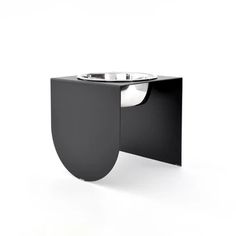 a black sink with a white bowl on it's side and an oval shaped basin in the middle