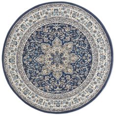 a blue and white rug with an intricate design on the center, surrounded by flowers