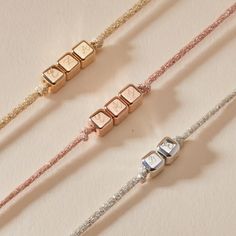 Glisten with love and sparkle through the colorful yet meaningful details of our Personalized Sparkling Dice Bracelet. Connected by a mini T-Bar clasp closure for easy wear, each bracelet features a colourful sparkling bracelet to match your charm metal of choice. With up to five delicate dice to hand-engrave, spell out a special name or represent little ones with individual initials.18K Champagne Gold Plated, 925 Sterling Silver or 18K Rose Gold PlatedDice Charm: 0.2 x 0.2Braid made of a durabl Adjustable Gold Cube Jewelry, Adjustable Rose Gold Jewelry With Letter Beads, Dice Bracelet, Sparkle Bracelet, Sliding Knot, Champagne Gold, Hand Engraving, Easy Wear, 18k Rose Gold