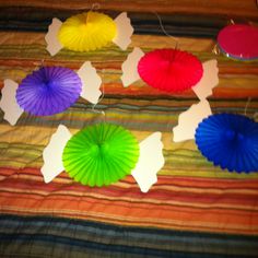 colorful paper fans are arranged on a bed