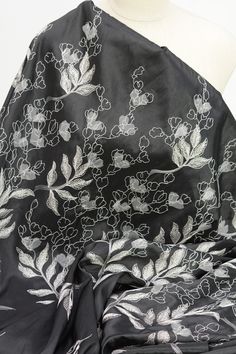 a black and white scarf with flowers on it