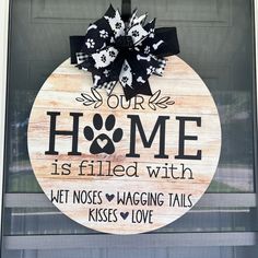 a wooden sign that says our home is filled with dogs wagging tails kisses love